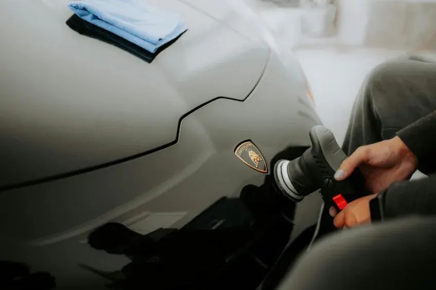 Detailer machine polishing a Lamborghini during paint correction