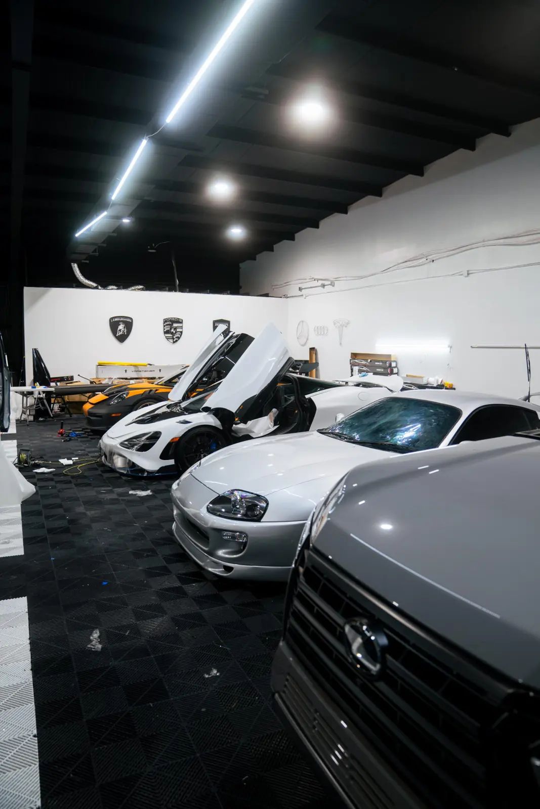 Supercars lined up inside JLE Customs' Houston shop