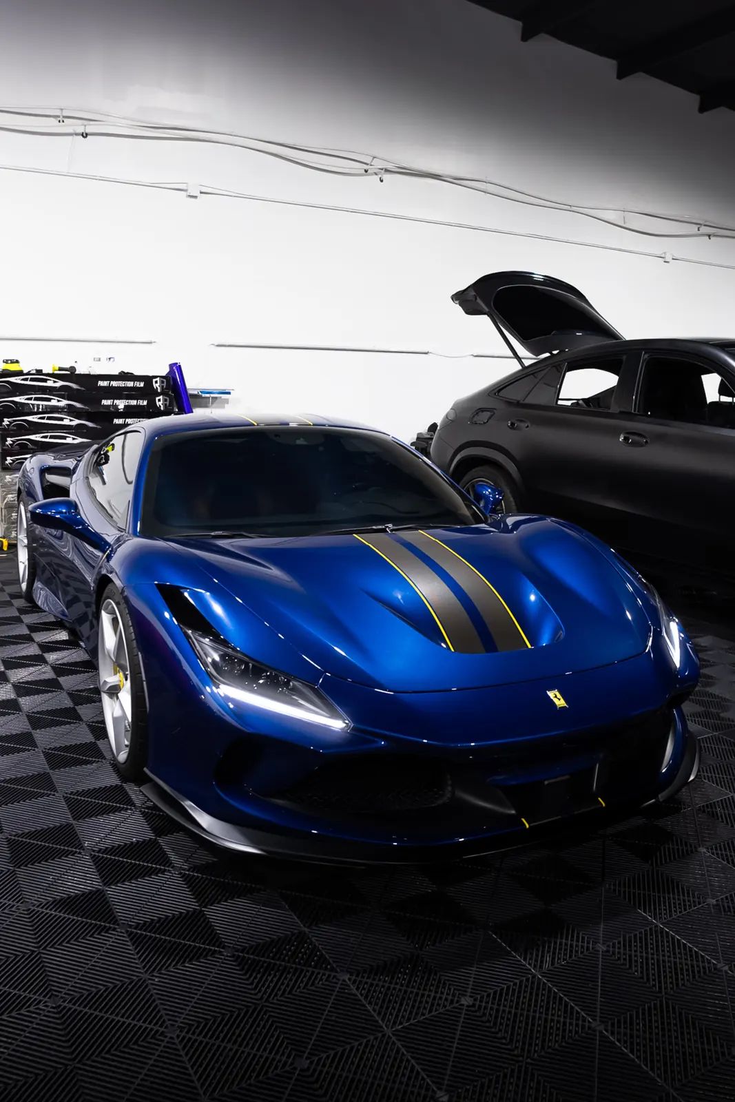 Blue Ferrari with paint protection film at JLE Customs
