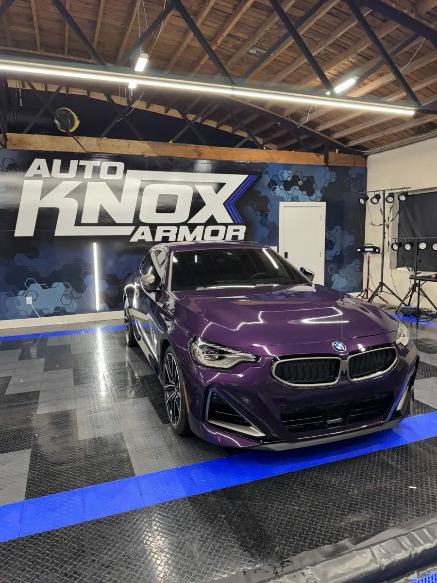 Purple BMW 2 Series with PPF in front of the Auto Knox Armor wall